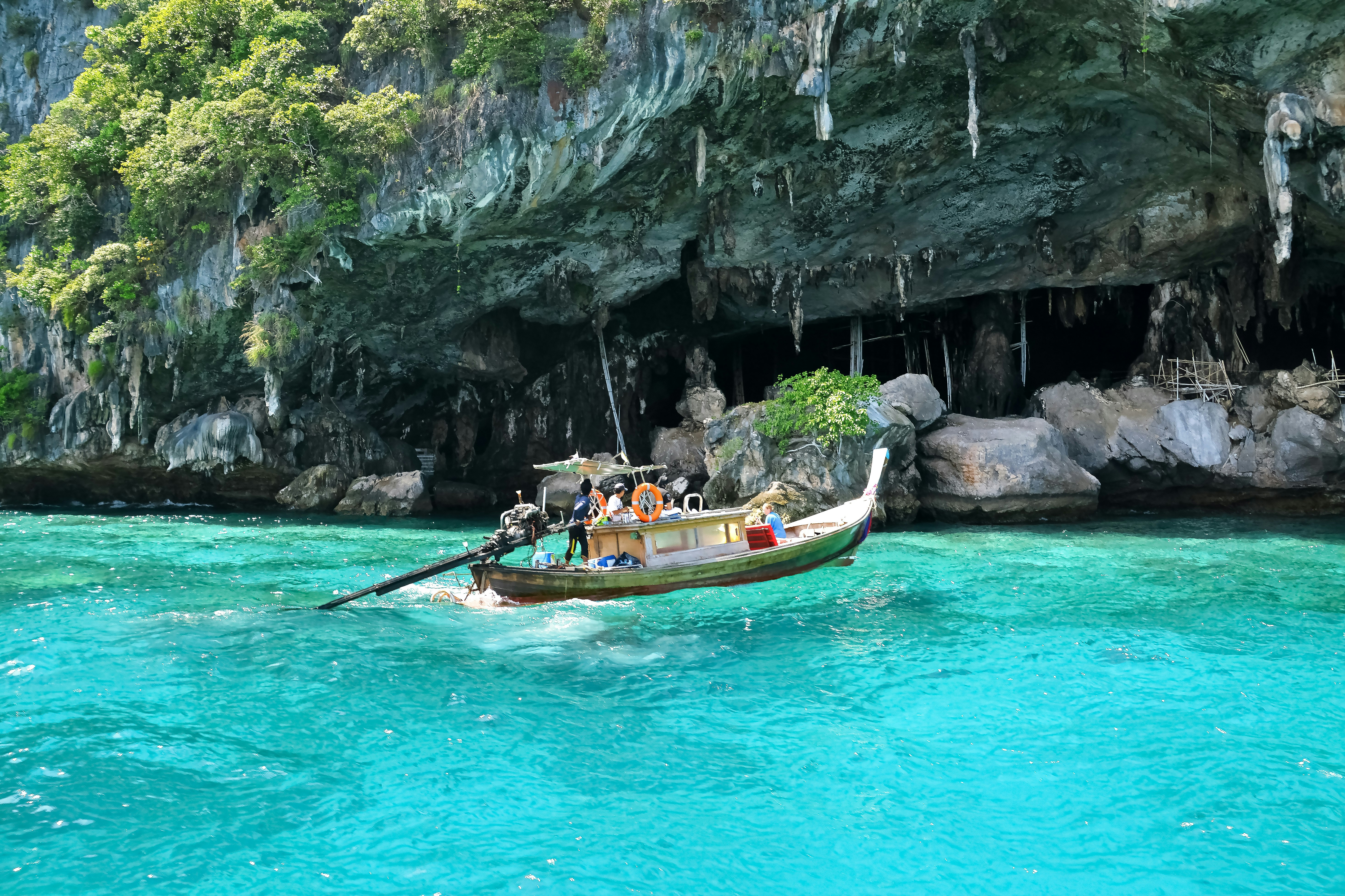 people riding on boat on blue water during daytime